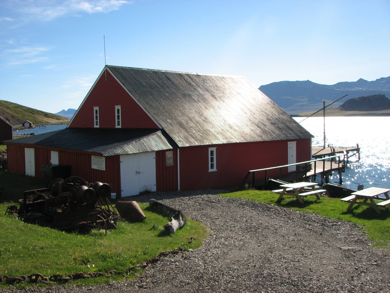The historic Randulffs Seahouse in Eskifjörður. It is a beautiful and sunny day. 